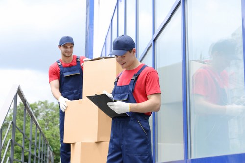 Professional movers preparing furniture for pick-up in Croydon