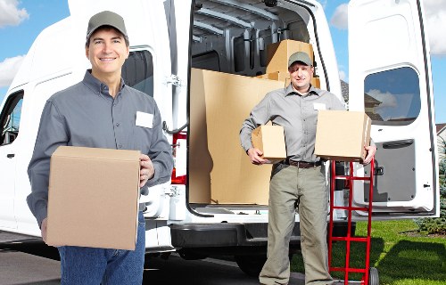 Movers packing items carefully