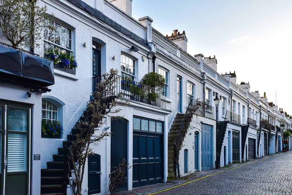 A row of historic terraced houses in South Norwood, Croydon, featuring Victorian-style architecture with decorative ironwork on the balconies and bay windows, built with brick and painted in light col